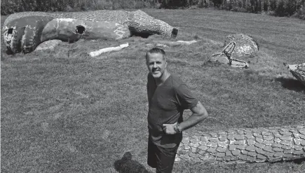  ?? ANGELA PETERSON/MILWAUKEE JOURNAL SENTINEL ?? Four years after buying the iconic Johnson’s Park dinosaur statue, its owner, Chad Covert, has plans to restore and prop up the 16-foot figure, which weighs 13,000 pounds, in the backyard of his Saukville home.