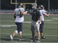  ?? PAUL DICICCO — FOR THE NEWS-HERALD PAUL DICICCO — FOR THE NEWS-HERALD ?? Liam Powers, quarterbac­k for Kirtland, runs the ball against Lake Catholic on Aug. 28. Powers ran for 92 yards and two scores in the Hornets’ 31-15 win.
Kirtland coach Tiger LaVerde congratula­tes Nick Schwartz after Schwartz scored a second-quarter touchdown against Lake Catholic on Aug. 28.