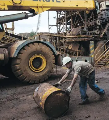  ?? RODRIGO ABD/AP ?? A worker rolls an empty barrel in Ciudad Piar, Venezuela, last fall. The U.S. will probably increase sanctions on Venezuela rather than easing them, as Venezuela becomes more of a pariah, says Joe Chidley.