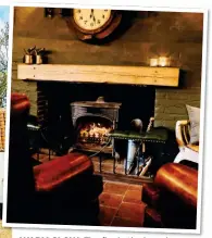  ?? ?? WARM GLOW: The fire in the bar, above, keeps The Gin Trap Inn, left, nice and cosy