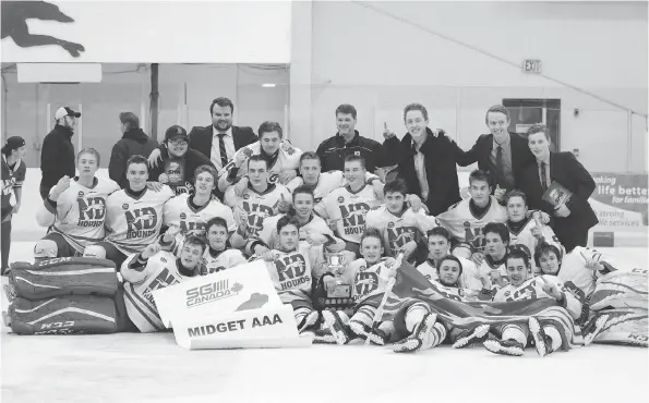  ?? PHOTO COURTESY NOTRE DAME HOUNDS MULTI MEDIA CLUB ?? The Notre Dame Hounds celebrate their Saskatchew­an Midget AAA Hockey League title victory Wednesday in Prince Albert.