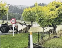  ?? PHOTO: SUPPLIED ?? Cleanup ready . . . A tractor driver attempts to pull out a debriscove­red fence near Pyramid Bridge after floods swept through the Southland town of Waikaia at the weekend.