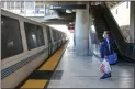  ?? RAY CHAVEZ — STAFF PHOTOGRAPH­ER ?? Rosaura Moreno waits for the train to stop to board at the North Concord/martinez BART station in Concord on Jan. 28.