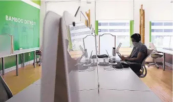  ?? RODNEY COLEMAN-ROBINSON/DETROIT FREE PRESS ?? Jordan Coin Jackson, 25, of Detroit, a software engineer for Quicken Loans, works at Bamboo Detroit office space on July 14.