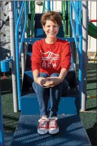  ?? (Arkansas Democrat-Gazette/Cary Jenkins) ?? Red Shoe Crew President Michelle Rupp shows off some red sneakers on the playground of the Ronald McDonald House near Arkansas Children’s Hospital.