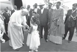  ?? STEPHEN WANDERA/ASSOCIATED PRESS ?? Pope Francis is welcomed by the president of Uganda, Yoweri Museveni, with hat, at Entebbe Internatio­nal Airport near the Uganda capital Kampala on Friday. Pope Francis is in Africa for a six-day visit that is taking him to Kenya, Uganda and the...