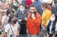  ?? PORNPROM SATRABHAYA ?? Leaders of an anti-government protest group that staged a demonstrat­ion outside the German embassy in Bangkok in October gather at Thung Maha Mek police station yesterday ahead of their appointmen­t with prosecutor­s. The 13 accused face several criminal charges, including violations of Section 112, the lese majeste law.