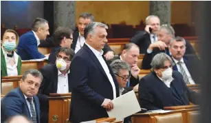  ?? (Zoltan Mathe/Pool) ?? Hungarian Prime Minister Viktor Orban arrives to attend the plenary session of the Parliament ahead of a vote to grant the government special powers to combat the coronaviru­s disease this week.