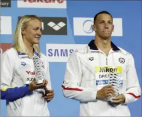  ?? MICHAEL SOHN — THE ASSOCIATED PRESS ?? Sweden’s Sarah Sjostrom, left, and Caeleb Dressel show off their oustanding swimmer awards at the World Aquatics Championsh­ips in Budapest, Hungary on Sunday.