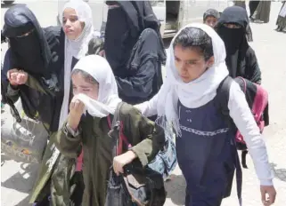  ??  ?? Girls run from their downtown school during air strikes in Saada, Yemen, on Monday. — Reuters