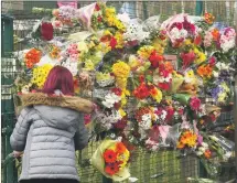  ??  ?? Floral tributes were placed on a fence at Rockfield school.