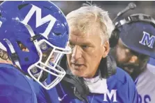  ?? STAFF FILE PHOTO BY MATT HAMILTON ?? Ralph Potter, center, wrote a letter that made the rounds on social media in July, with the McCallie football coach advocating for high school sports to take place amid the coronaviru­s pandemic because of the benefits it would provide young people. Potter then led the Blue Tornado to a second straight TSSAA Division II-AAA title this fall.