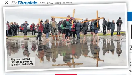  ??  ?? Pilgrims carrying crosses to the Holy Island of Lindisfarn­e