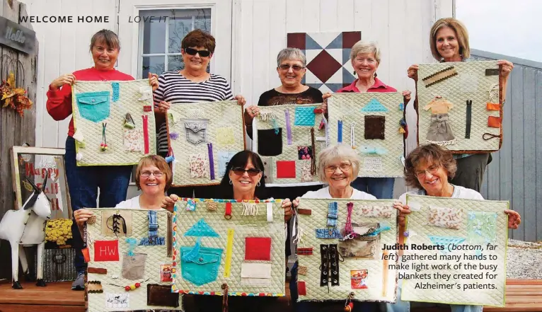  ??  ?? Judith Roberts (bottom, far left) gathered many hands to make light work of the busy blankets they created for Alzheimer's patients.