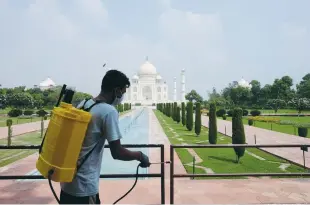  ?? (Alasdair Pal/Reuters) ?? A MAN sanitizes railings in the premises of Taj Mahal after a previous opening of the monument to visitors, amid the coronaviru­s outbreak, in Agra, India, last September.