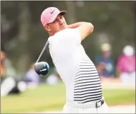  ?? Mike Ehrmann / Getty Images ?? Brooks Koepka plays his shot from the third tee during the second round of the Masters at Augusta National Golf Club on Friday.