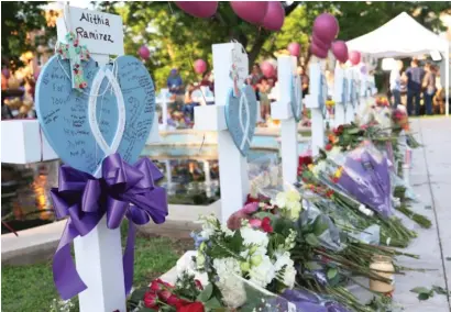  ?? MICHAEL M. SANTIAGO/GETTY IMAGES ?? Memorials for victims of the mass shooting at Robb Elementary School in Uvalde, Texas. An 18-year-old who had recently purchased guns killed 19 children and two adults Tuesday.