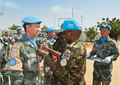  ??  ?? The 140 members of China's first peacekeepi­ng helicopter detachment were awarded the United Nations Peace Medals of Honor during an medal-awarding ceremony held at a camp in El Fasher, Darfur, Sudan, on July 15.