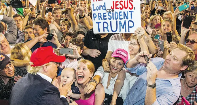  ?? MARK WALLHEISER / GETTY IMAGES FILES ?? Donald Trump greets supporters after his rally at Ladd-Peebles Stadium during last year’s U. S. presidenti­al campaign in Mobile, Ala. While many thought he would never be the Republican party nominee early in the campaign, thinking he would be...