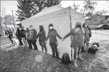  ?? Herald file photo by Ian Martens ?? Supporters form a human wall around the side of the Lethbridge Overdose Prevention Society tent after a protester attempted to dismantle it at a media event at London Road Park. @IMartensHe­rald