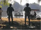  ?? MARCO UGARTE AP ?? Mexican National Guard members stand watch over the Suchiate River, near Ciudad Hidalgo, Mexico.