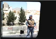  ??  ?? An Afghan policeman keeps watch at a checkpoint on the Ghazni highway, in Maidan Shar, the capital of Wardak province, Afghanista­n. — Reuters photo