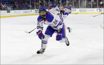  ?? PHOTO BY RICH GAGNON — UML ATHLETICS ?? Umass Lowell forward Scout Truman chases after the puck Friday night during a game against New Hampshire at the Tsongas Center.