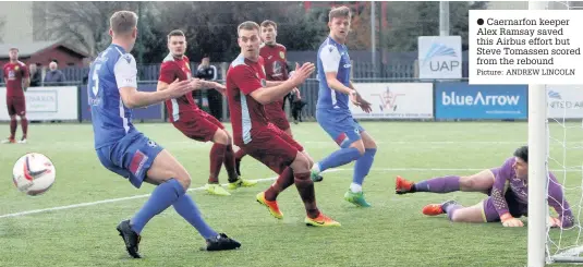  ?? Picture: ANDREW LINCOLN ?? ● Caernarfon keeper Alex Ramsay saved this Airbus effort but Steve Tomassen scored from the rebound