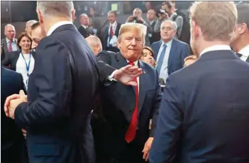  ?? PABLO MARTINEZ MONSIVAIS/AFP ?? US President Donald Trump pats a world leader on the back as he makes his way to his seat for a meeting of the North Atlantic Council at NATO headquarte­rs in Brussels on July 11.