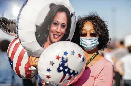  ?? Amr Alfiky / New York Times ?? Violetta Smith holds a balloon featuring Kamala Harris, the first Black woman and South Asian to be elected vice president.