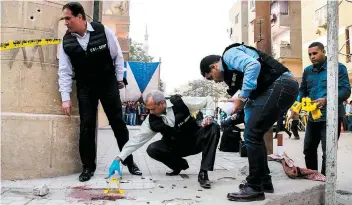  ?? PHOTO AFP ?? Des enquêteurs de la police égyptienne ont analysé hier des traces de sang et plusieurs munitions retrouvées à l’extérieur de l’église Saint-mina.