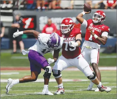  ?? Thomas Metthe/Arkansas Democrat-Gazette ?? Pass protection: Arkansas quarterbac­k KJ Jefferson (1) throws a pass while getting a block from offensive lineman Patrick Kutas (75) during the first quarter of the Razorbacks’ 56-13 win on Saturday, Sept. 2, 2023, at War Memorial Stadium in Little Rock.