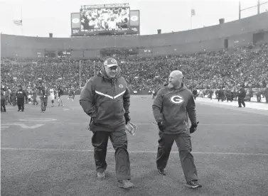  ?? AP Photo/Jeffrey Phelps ?? ■ Green Bay Packers head coach Mike McCarthy, left, leaves the field after a game against the Arizona Cardinals on Sunday in Green Bay, Wis. McCarthy was fired after the game.