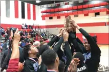  ?? NATE BARNES — THE NEWS-HERALD ?? Richmond Heights celebrates with the Division IV Norton District trophy after the Spartans defeated Rittman, 69-47, March 6.