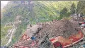  ??  ?? A vehicle buried under the debris after the landslide in Kinna district on Thursday