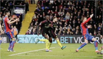  ?? —AP ?? LONDON: Manchester City’s Yaya Toure, centre left, celebrates scoring his side’s second goal during the English Premier League soccer match between Crystal Palace and Manchester City at Selhurst Park stadium in London, yesterday.