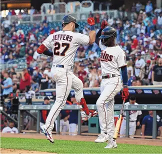  ?? STACY BENGS/ASSOCIATED PRESS ?? The Minnesota Twins’ Ryan Jeffers (27) is greeted by teammate Nick Gordon after Jeffers hit a home run during the fifth inning of Wednesday’s game against the New York Yankees in Minneapoli­s.