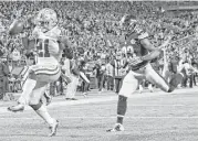  ?? Don Wright / Associated Press ?? Cowboys running back Ezekiel Elliott dances into the end zone ahead of Steelers safety Mike Mitchell for the game-winning score with nine seconds left.