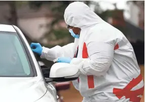  ??  ?? Dr. Andrenette Fleming administer­s drive-thru COVID-19 tests from her office.