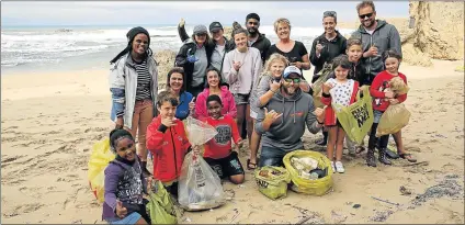  ??  ?? BEACH RESCUERS: Dean Knox surfer and environmen­tal educator (white cap) with some of the volunteers who helped clean up the Nahoon coastline