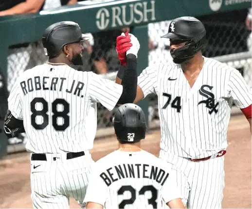  ?? CHARLES REX ARBOGAST/AP ?? Luis Robert Jr. celebrates his two-run home run off Athletics starting pitcher Ken Waldichuk with Eloy Jimenez in the fifth inning Thursday.