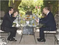  ?? (Mark Nayman/GPO) ?? PRESIDENT ISAAC HERZOG and Prime Minister Naftali Bennett enjoy a congenial meeting and repast in the arbor of the gardens at the President’s Residence.