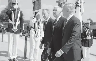  ?? AP Photo/Evan Vucci ?? ■ Vice President Mike Pence, center, is greeted by Deputy Secretary of Defense Pat Shanahan, left, and Secretary of Defense Jim Mattis before speaking at an event on the creation of a United States Space Force on Aug. 9 at the Pentagon.