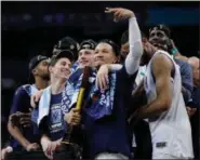 ?? DAVID J. PHILLIP — THE ASSOCIATED PRESS ?? Villanova players watch the screen as they celebrate after the championsh­ip game of the Final Four NCAA college basketball tournament against Michigan, Monday in San Antonio. Villanova won, 79-62.