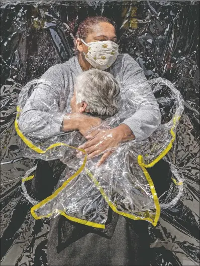  ?? (Politiken, Panos Pictures/Mads Nissen) ?? In this image released by World Press Photo by Mads Nissen of Politiken, Panos Pictures, which won the World Press Photo of the Year award, and the first prize in the General News Singles category, titled The First Embrace, shows Rosa Luzia Lunardi, 85, embraced by nurse Adriana Silva da Costa Souza at Viva Bem care home in Sao Paulo, Brazil, on Aug. 5.