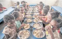  ?? AFP ?? Primary schoolchil­dren in southern Madagascar eat lunch offered by the World Food Programme’s Under-nutrition Prevention Programme.