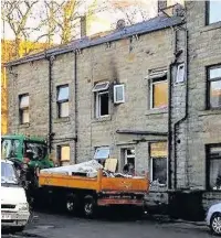  ??  ?? Smoke damage outside the home on West View Road