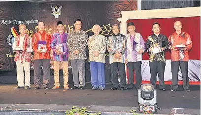  ??  ?? DIHARGAI: Tun Taib (tengah) bersama Karim (empat kiri) dan tetamu kehormat lain merakam kenangan bersama para penerima Anugerah Sastera Negeri Sarawak 2017.