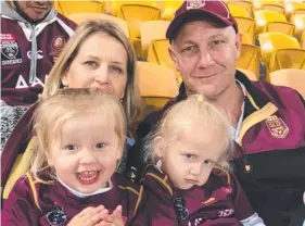  ??  ?? Jarrod Wallace's parents Sharon and Craig with his daughters Lara and Peyton. Left: Celebratio­ns in the Queensland dressing room after the game.