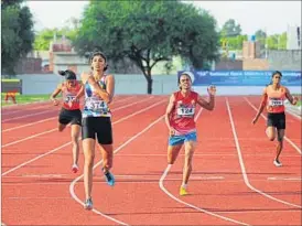  ?? DEEPAK GUPTA / HT ?? Ashwini Akkunji finishes the 400m race ahead of her competitor­s at the National Athletics Championsh­ips at SAI Centre in Lucknow.